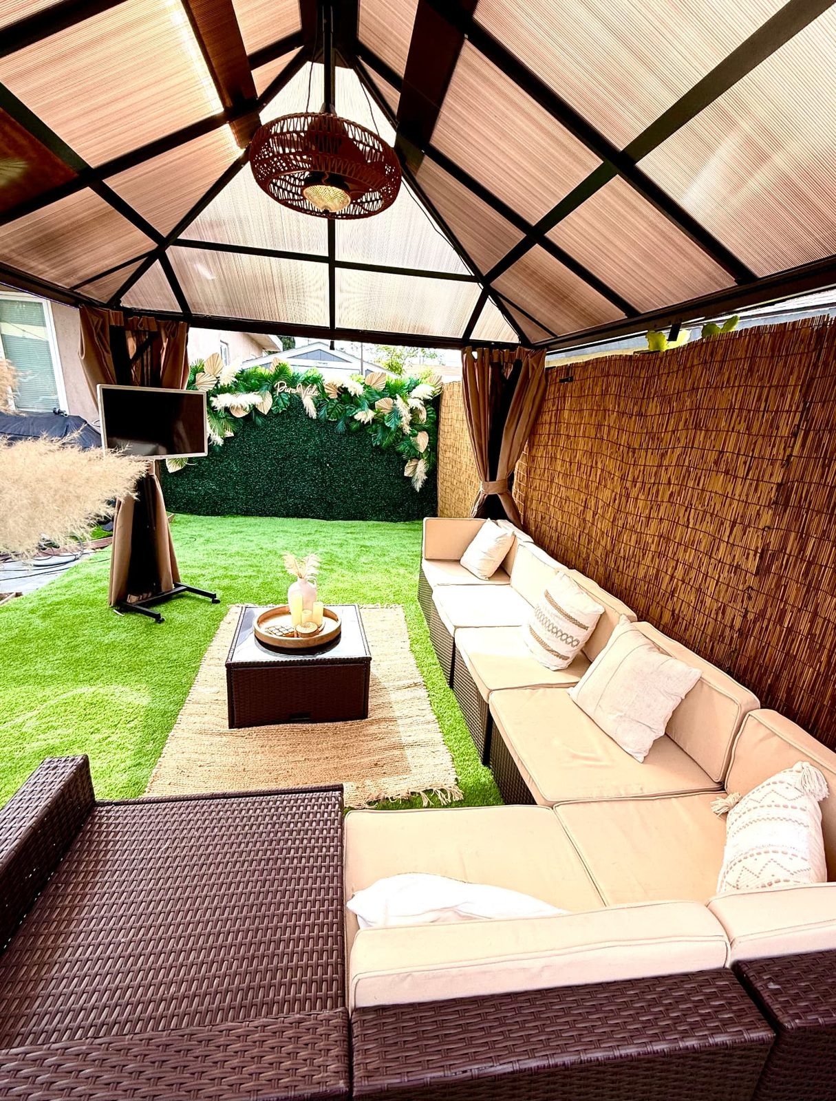 Covered cabana lounge facing the Pura Vida greenery wall