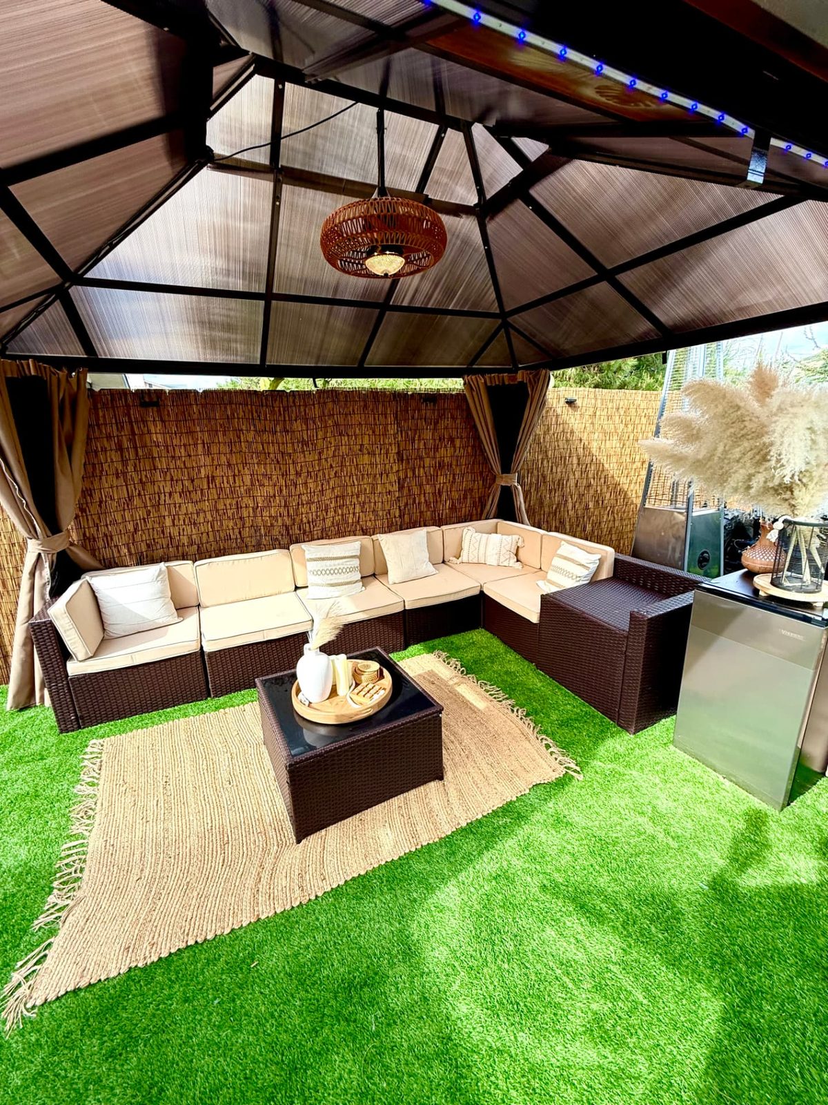 Covered cabana with a large sectional and jute rug