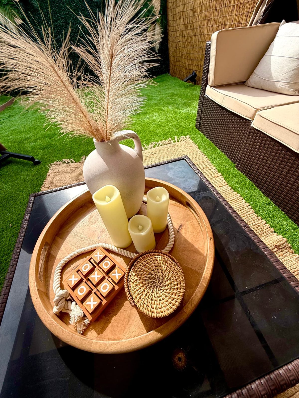 Wood tray with candles and tic-tac-toe on the cabana table
