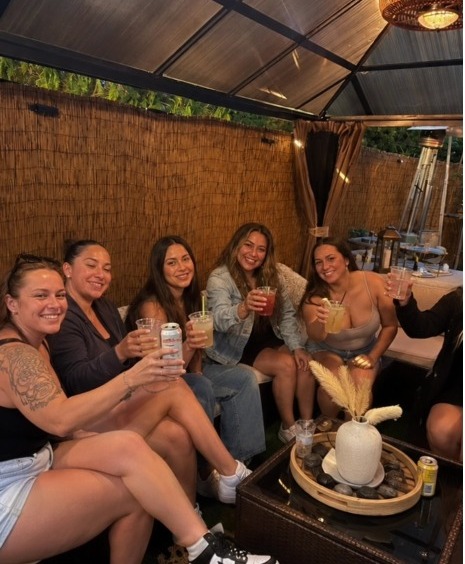 Friends toasting drinks in the covered cabana