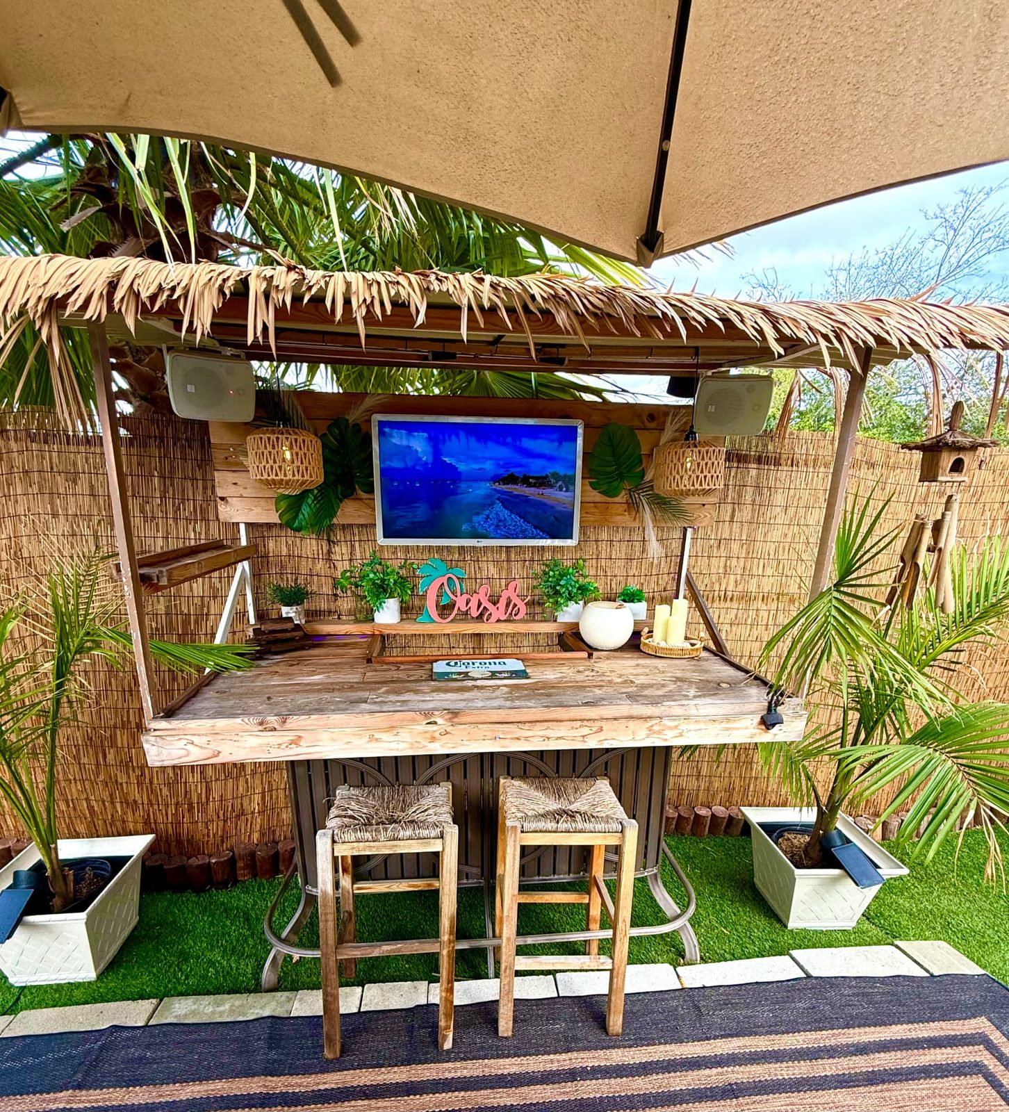 The Oasis tiki bar with bar stools, sound and screen